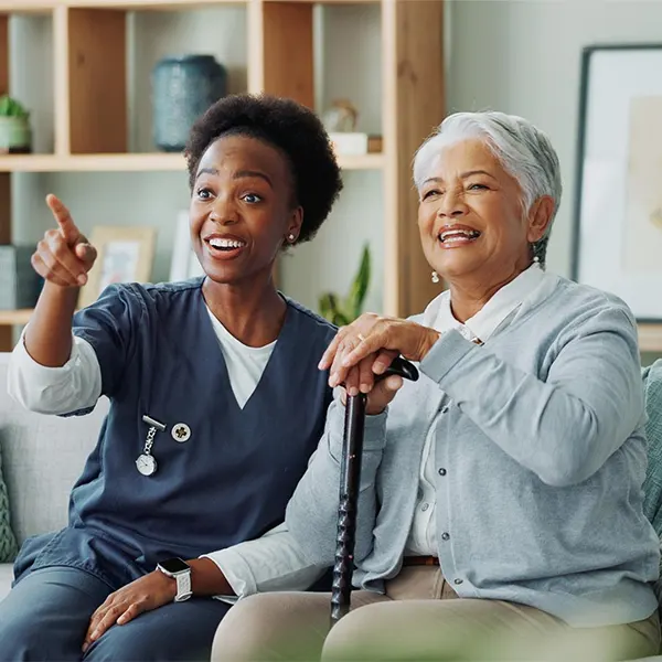 Caregiver holding hands with an elderly client